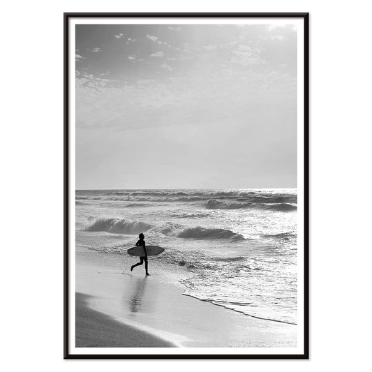 Black and white poster of a surfer with a board entering the ocean titled Surfer in Portugal by artist Black, with black aluminium frame on white background