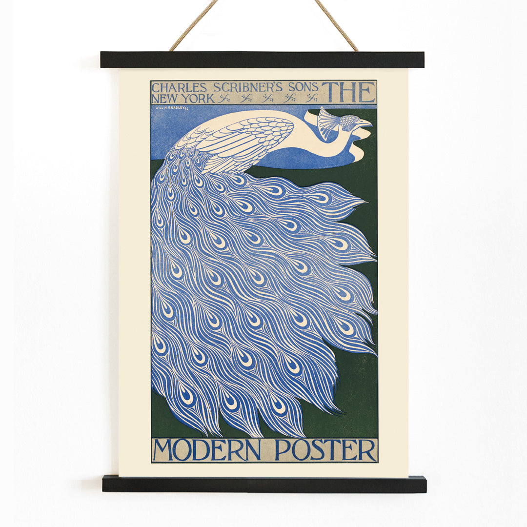 Elegant blue and white peacock with flowing feathers illustration from The Modern Poster by Will Bradley, with wooden magnetic frame on white background