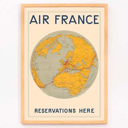 Vintage Air France travel poster by E Giraud showing world map with airline routes highlighted in red, framed and displayed in modern living room decor