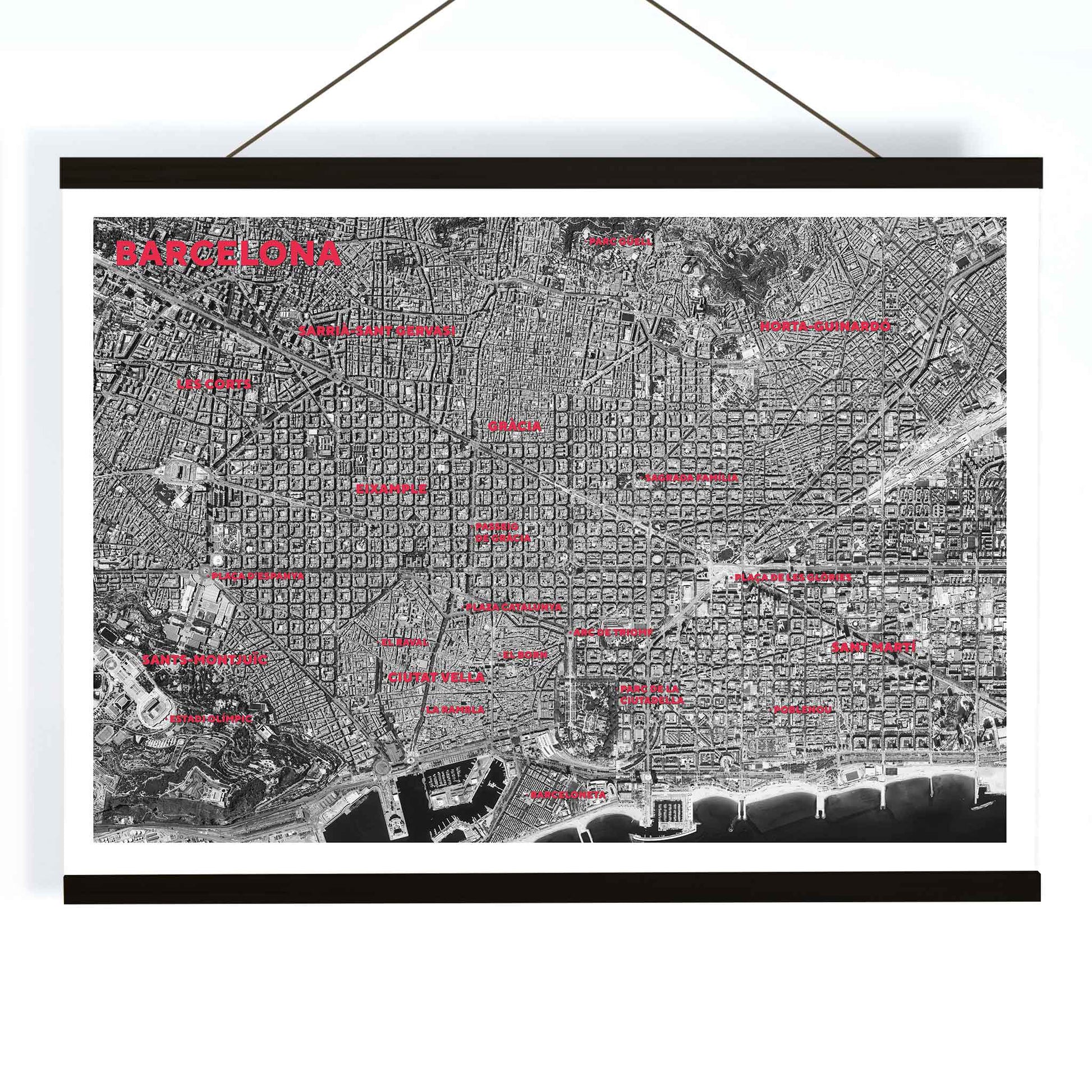 Moryarty Barcelona satellite city map poster in bold black and white aerial style showing city grid districts landmarks monuments and coastline, with wooden magnetic frame on white background