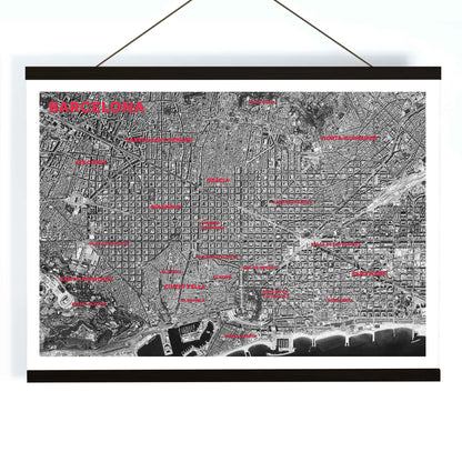 Moryarty Barcelona satellite city map poster in bold black and white aerial style showing city grid districts landmarks monuments and coastline, with wooden magnetic frame on white background