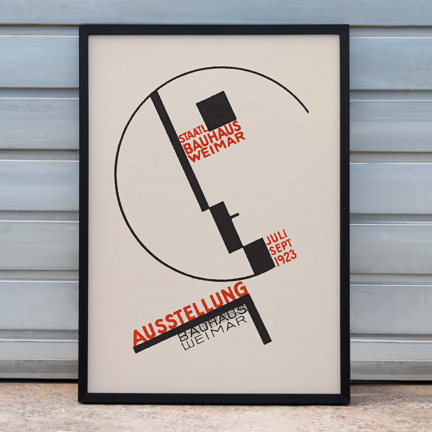 Dörte Helm Bauhaus Weimar exhibition poster with bold black geometry and red typography on warm beige background, framed and displayed in home decor