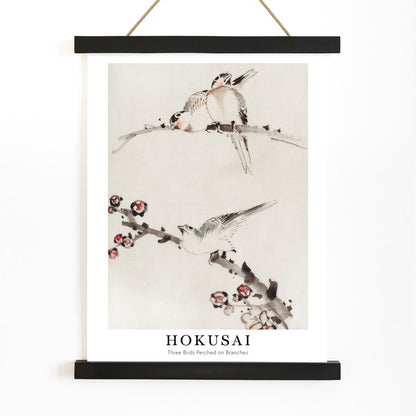 Three birds perched on branches with blossoms watercolor painting and poster artwork by Katsushika Hokusai, with wooden magnetic frame on white background