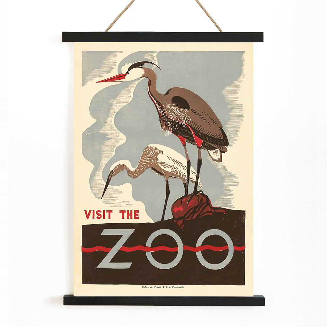Visit the zoo poster by Federal Art Project WPA Pennsylvania showing two herons standing on a rock with text by the artist, with wooden magnetic frame on white background