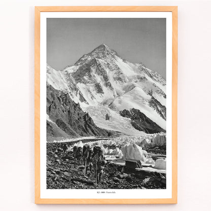 Black and white photo by Vittorio Sella of mountaineers trekking toward K2 over the Godwin Austen glacier titled Le pic K2 vue prise du glacier Godwin Austen, framed and displayed in modern living room decor