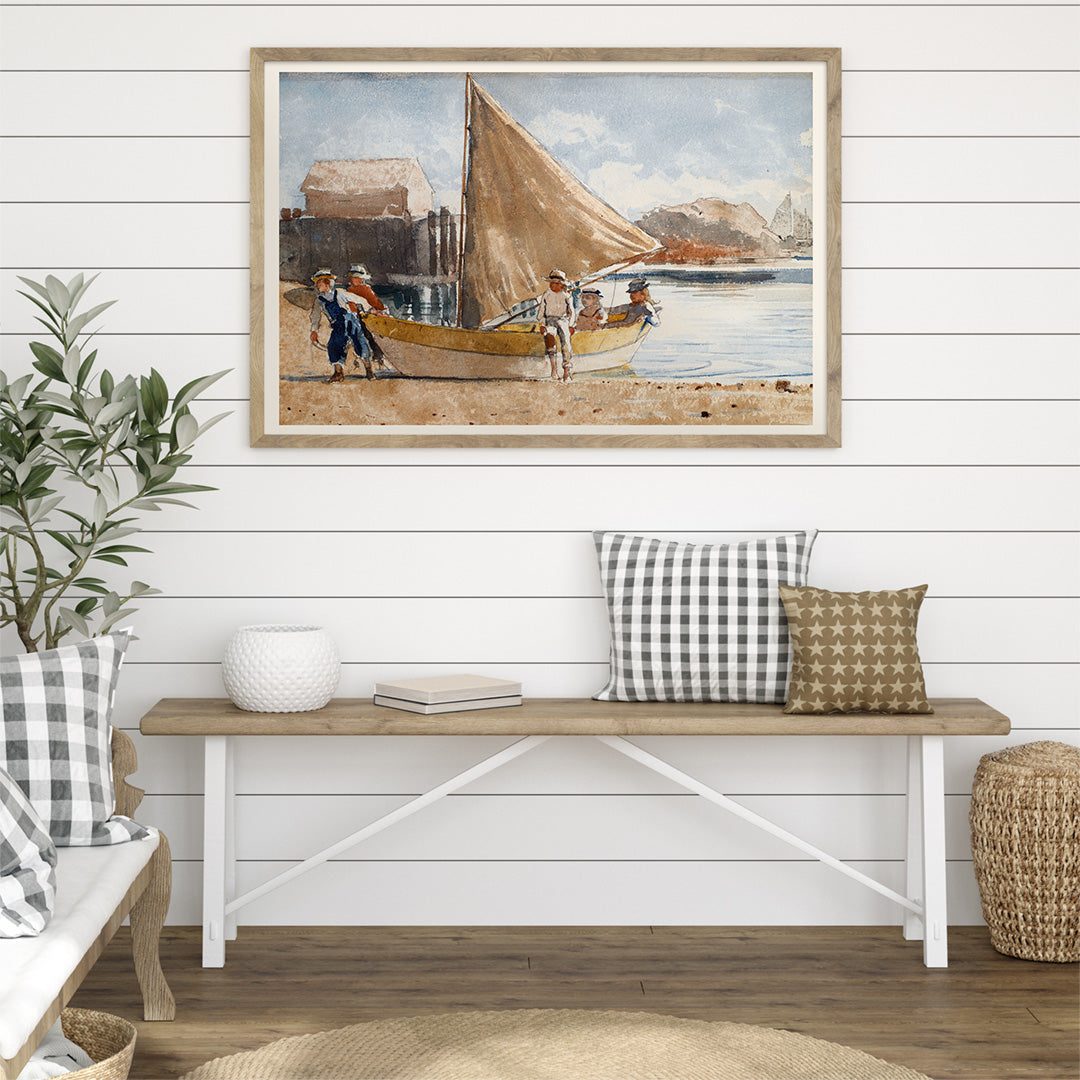 Summertime by Winslow Homer painting of children on a sailboat at the beach and by the sea with a sailboat on the shore displayed in a black frame, framed and displayed in home decor