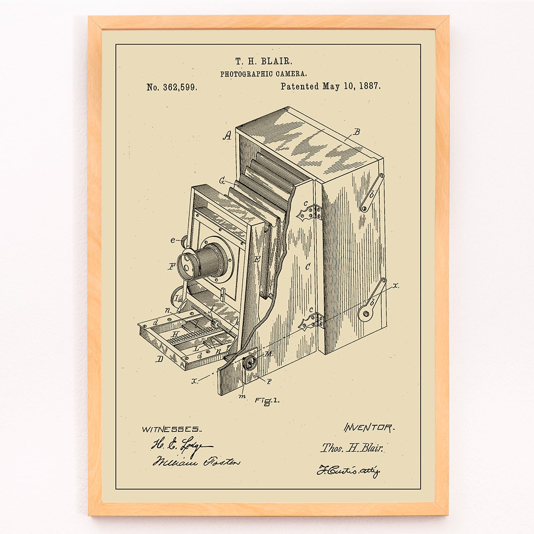 Vintage photographic camera patent diagram and detailed poster illustration by TH Blair, framed and displayed in modern living room decor