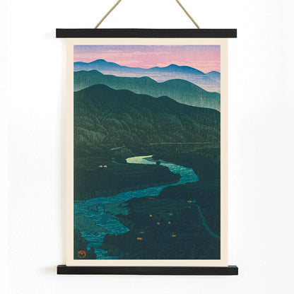 Ecchu Umidani Pass by Kawase Hasui landscape artwork showing mountains and a winding river at dawn and dusk, with wooden magnetic frame on white background