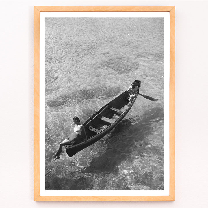 Closeup detail of Fashion model on boat edge with man rowing in clear water Montego Bay Jamaica by Toni Frissell artwork poster