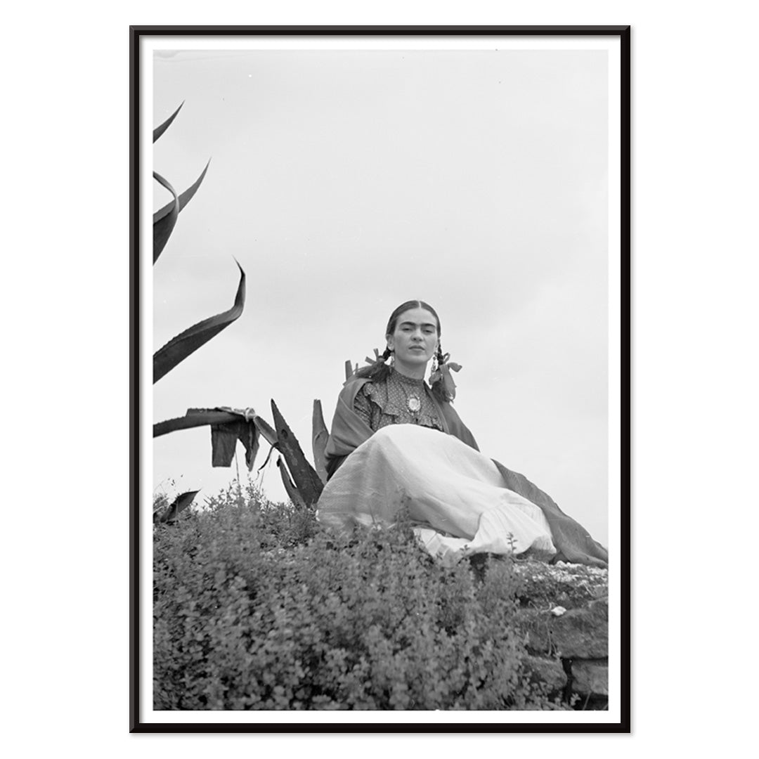 Frida Kahlo and Senora Diego Rivera seated beside agave plant photographed by Toni Frissell poster artwork, with black aluminium frame on white background
