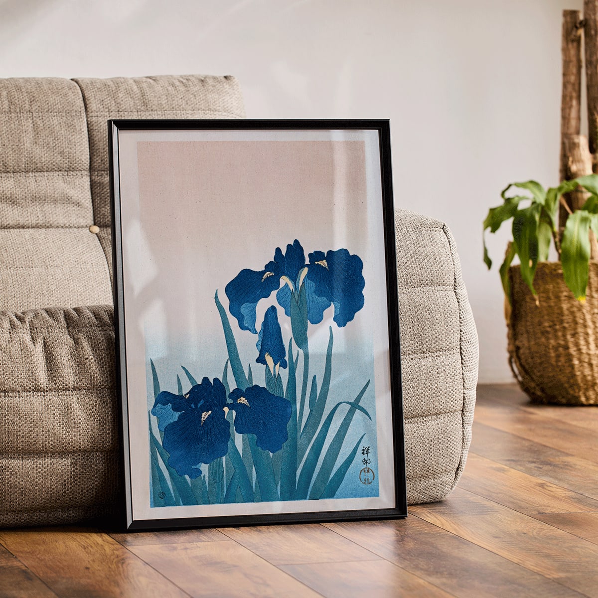 Poster of vibrant blue irises with green leaves on a gradient background artwork Blue Irises by Ohara Koson, framed and displayed in modern living room decor