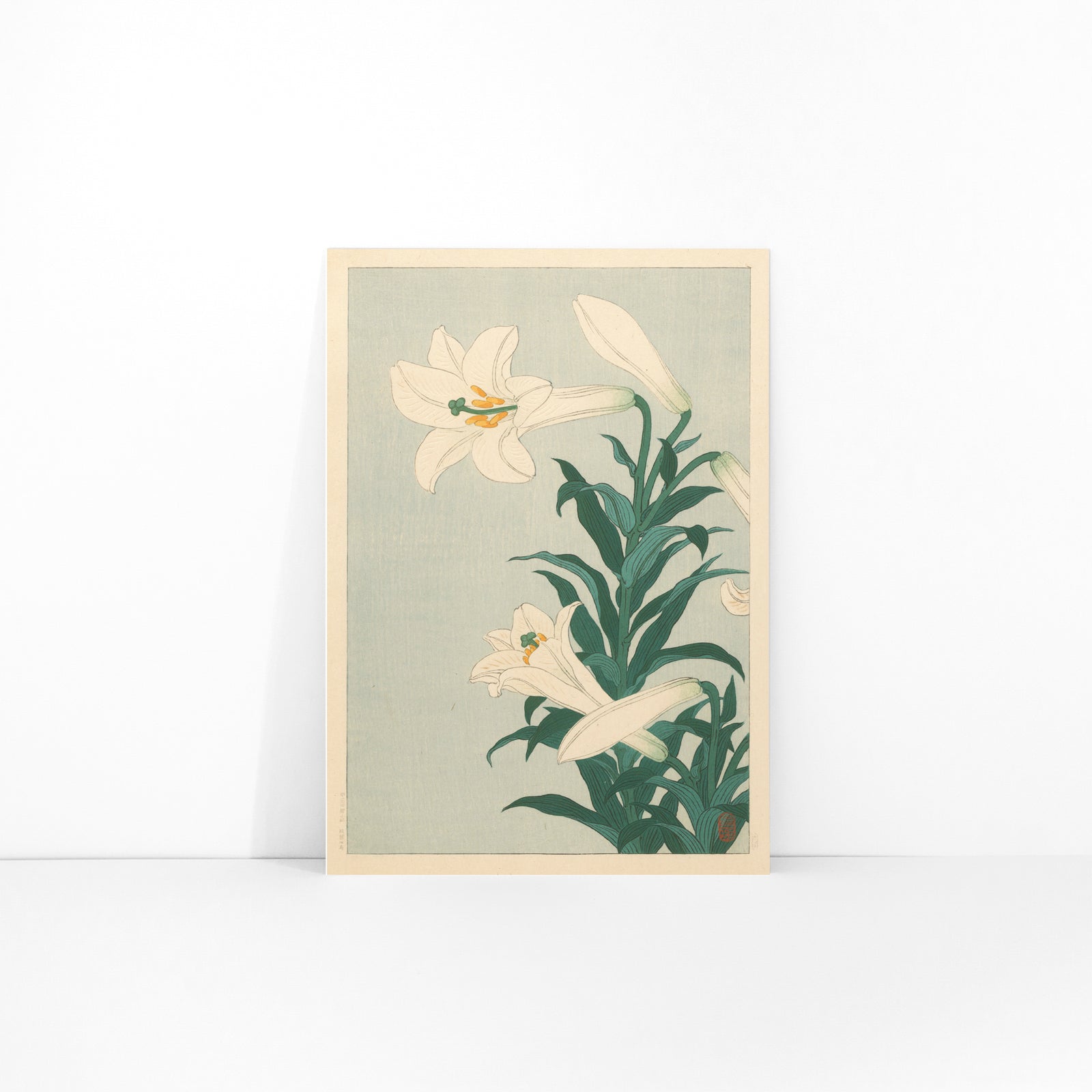 White lilies floral artwork by Ohara Koson with green leaves on light blue background poster Lelies flowers, framed and displayed in modern living room decor