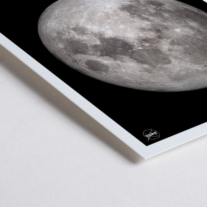 Closeup detail of NASA poster of Earth Moon detailed lunar surface image with black background white border and labeled Moon