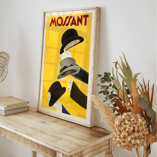 Vibrant poster by Leonetto Cappiello featuring three hands holding hats with yellow background and Mossant text, framed and displayed in home decor