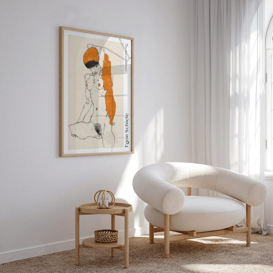 Standing Nude with Orange Drapery by Egon Schiele poster showing a nude woman with orange drapery on her head and side, framed and displayed in home decor