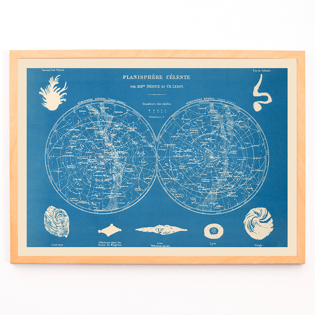 Celestial planisphere star map poster by Claude Joseph Drioux featuring constellations and astronomical illustrations on blue background, framed and displayed in modern living room decor
