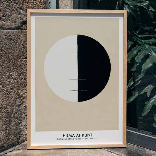 Black and white circle artwork poster Buddha Standpoint In Early Life by Hilma AF Klint with divided circle on beige background, framed and displayed in home decor