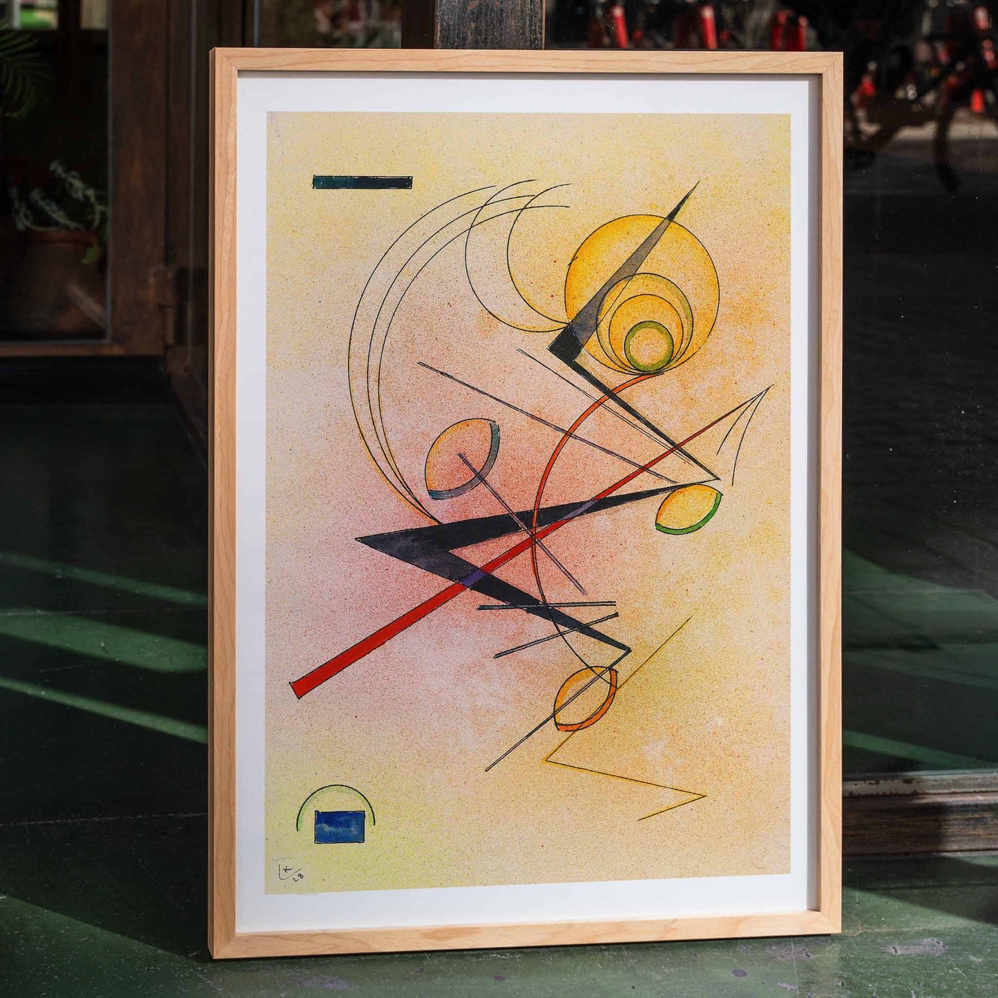 Abstract geometric poster with colored lines and shapes over a warm background by Wassily Kandinsky Kleines Warm, framed and displayed in home decor