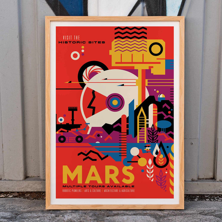 Colorful NASA Mars travel poster featuring abstract Mars landscape and rover artwork with text Mars Visit the historic sites by NASA, framed and displayed in home decor