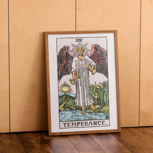 Temperance tarot card by Rider Waite featuring an angel with wings pouring liquid between two cups illustration and poster, framed and displayed in home decor