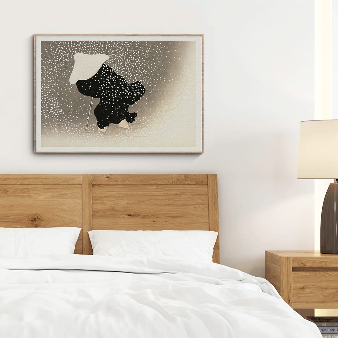 Poster of Tomoe no yuki by Kamisaka Sekka showing a snowy scene with a silhouette of a figure in dark attire under heavy snowfall wearing a white hat and holding a walking stick, framed and displayed in home decor