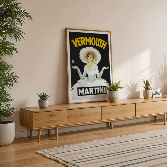 Vermouth Martini by Marcello Dudovich vintage poster art featuring an elegant woman in white holding a glass against a black background, framed and displayed in home decor